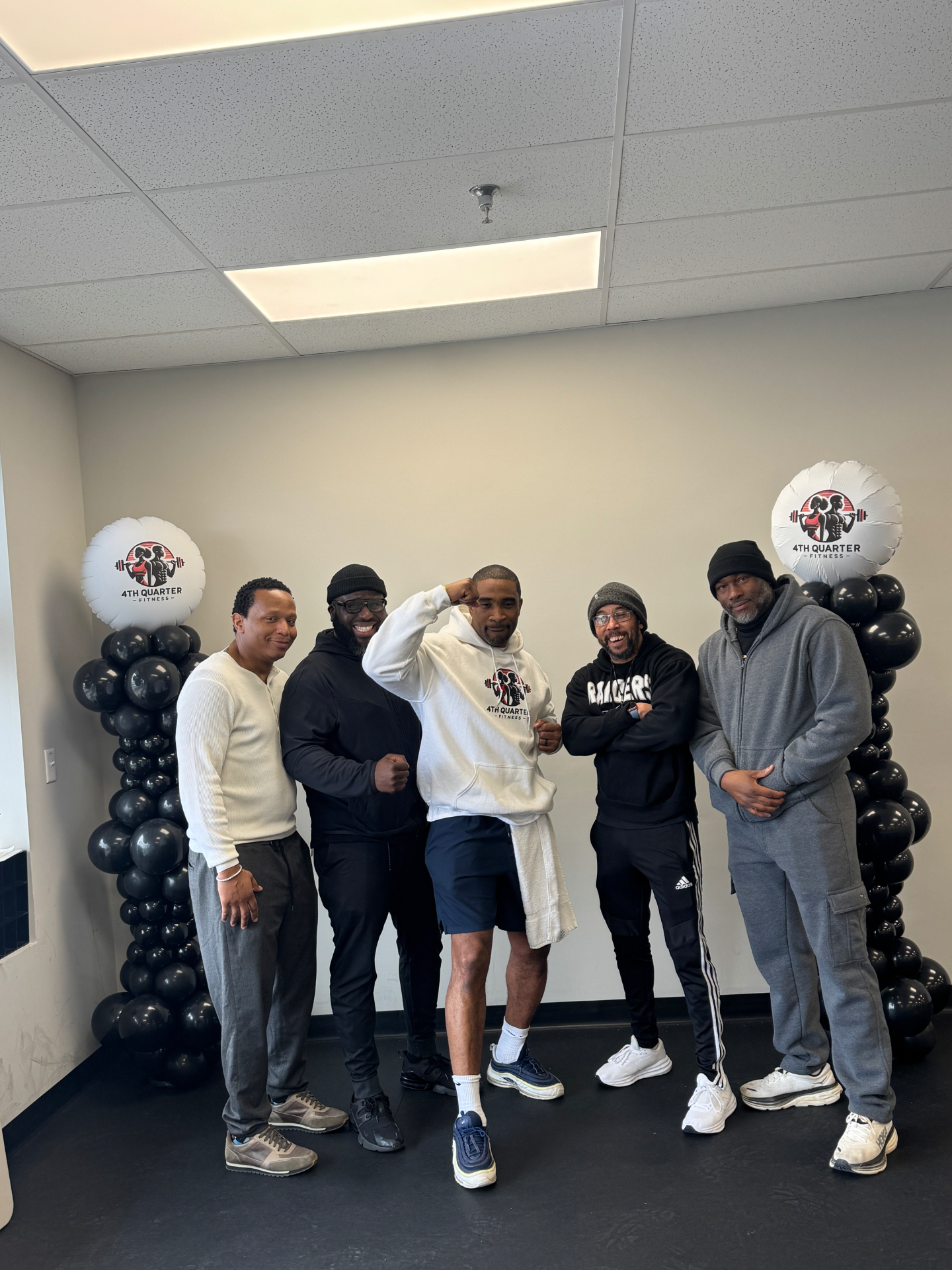 Coach C and crew flexing at 4th Quarter Fitness event